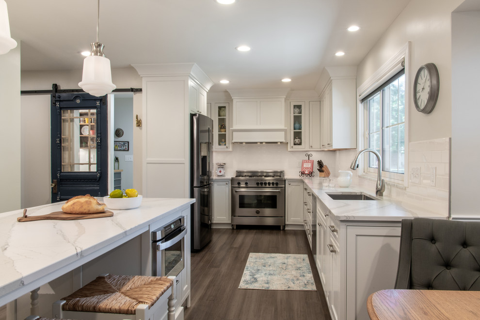 Inspiration for a transitional kitchen remodel in St Louis with white cabinets, white backsplash and white countertops
