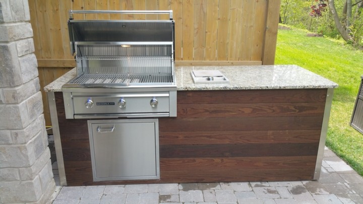 This is an example of a small contemporary verandah in Toronto with an outdoor kitchen.