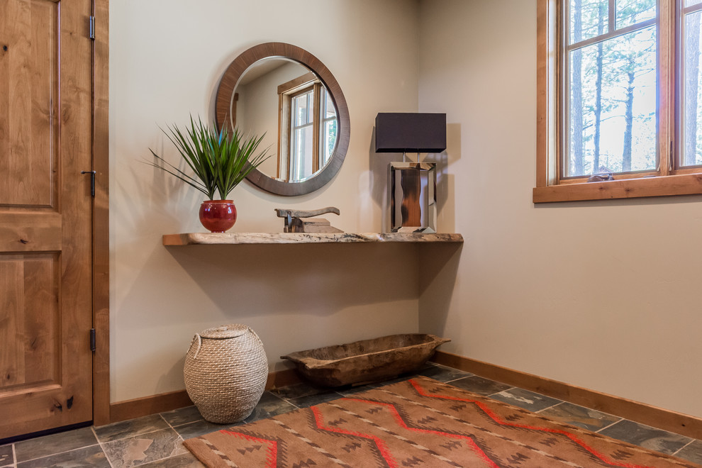 This is an example of a mid-sized transitional foyer in Other with beige walls, slate floors and grey floor.