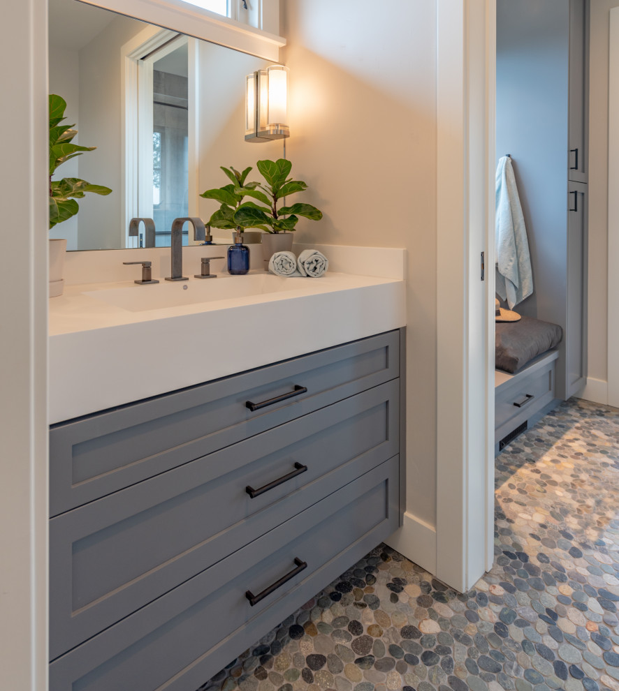 Mid-sized country 3/4 bathroom in San Francisco with shaker cabinets, distressed cabinets, an alcove shower, a two-piece toilet, blue tile, porcelain tile, grey walls, pebble tile floors, a trough sink, concrete benchtops, grey floor, a hinged shower door, white benchtops, a single vanity and a built-in vanity.