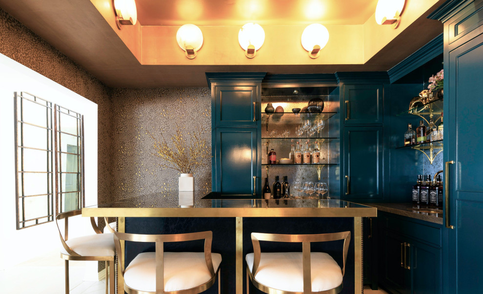 Design ideas for a transitional u-shaped seated home bar in Los Angeles with recessed-panel cabinets, blue cabinets, mirror splashback and brown benchtop.