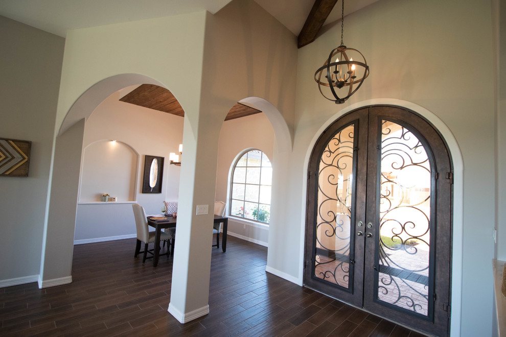 Inspiration for a mid-sized transitional medium tone wood floor and brown floor front door remodel with gray walls and a brown front door