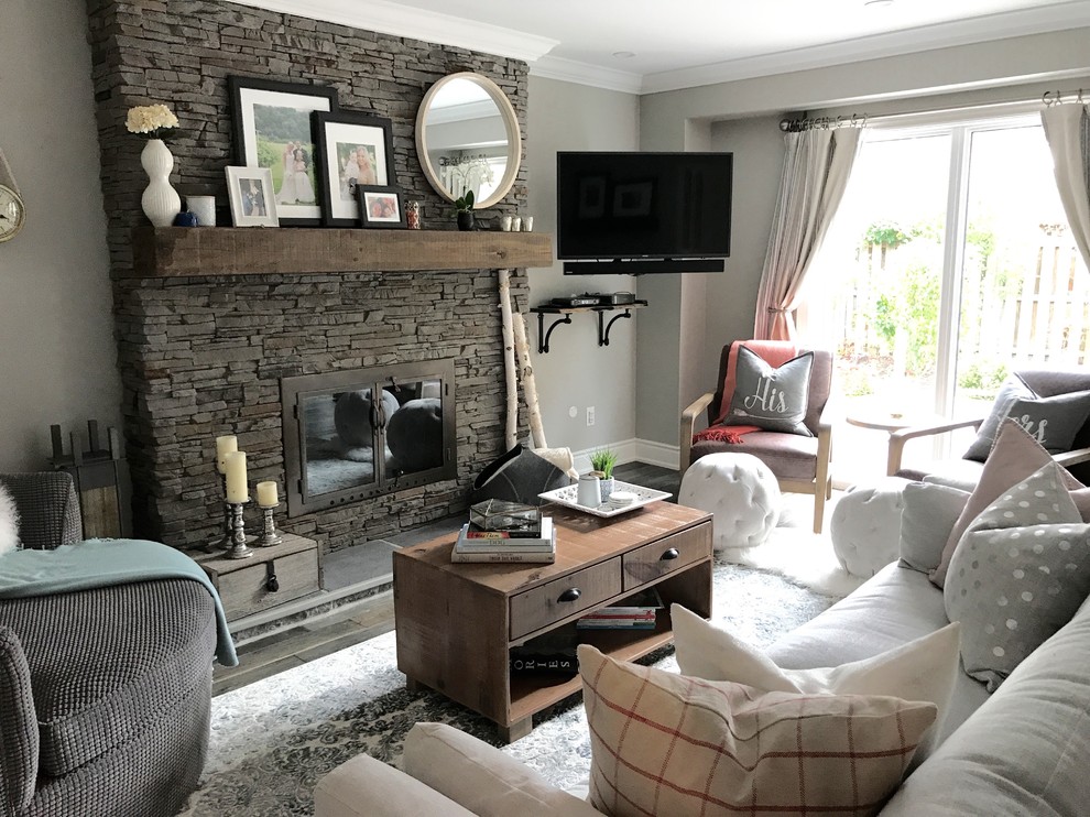 Inspiration for a mid-sized traditional enclosed family room in Toronto with grey walls, dark hardwood floors, a standard fireplace, a stone fireplace surround, a corner tv and brown floor.