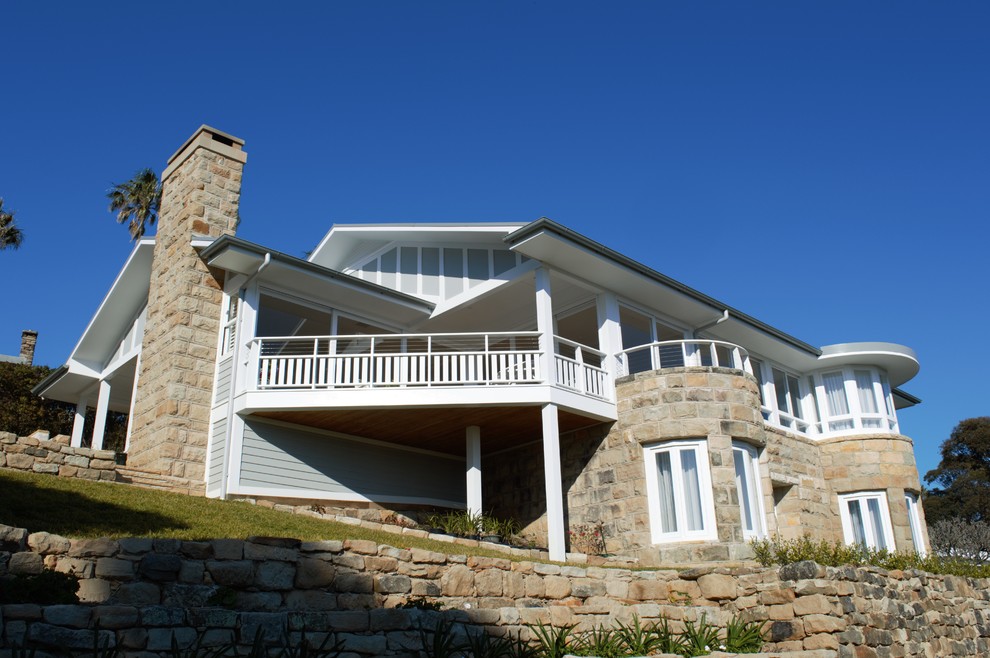 Photo of a large beach style two-storey grey exterior in Sydney with concrete fiberboard siding.