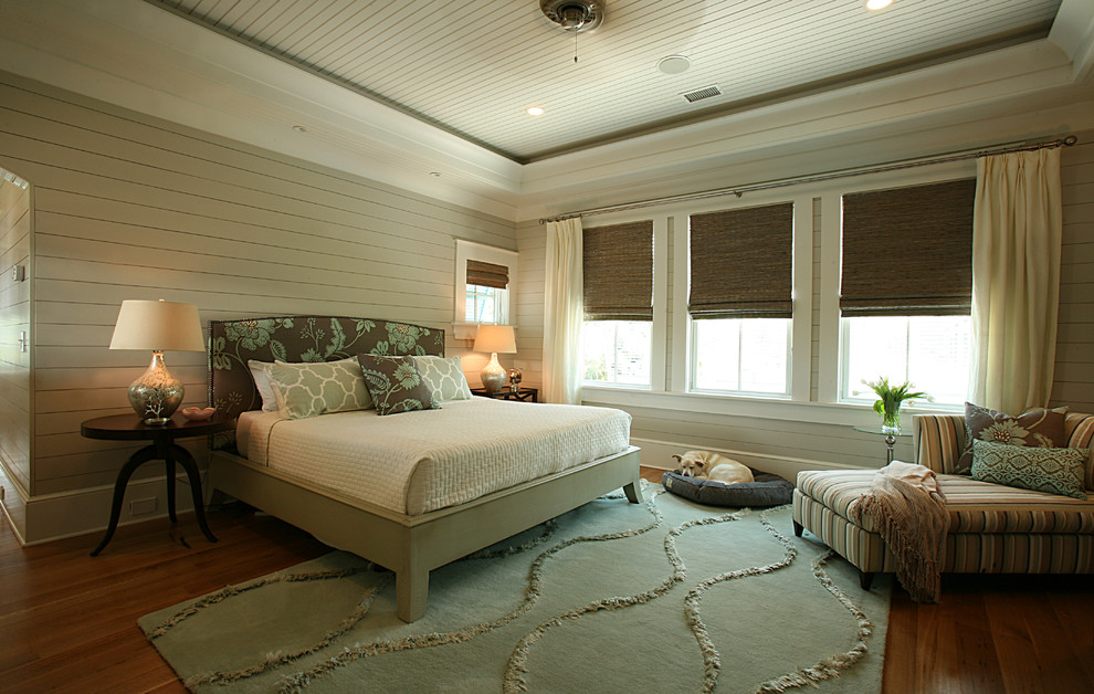 Photo of a mid-sized tropical master bedroom in Atlanta with beige walls, medium hardwood floors and no fireplace.