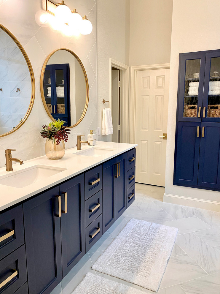 This is an example of a mid-sized contemporary master bathroom in Dallas with shaker cabinets, blue cabinets, an open shower, a one-piece toilet, gray tile, porcelain tile, grey walls, porcelain floors, an undermount sink, engineered quartz benchtops, grey floor, an open shower, white benchtops, a double vanity and a floating vanity.