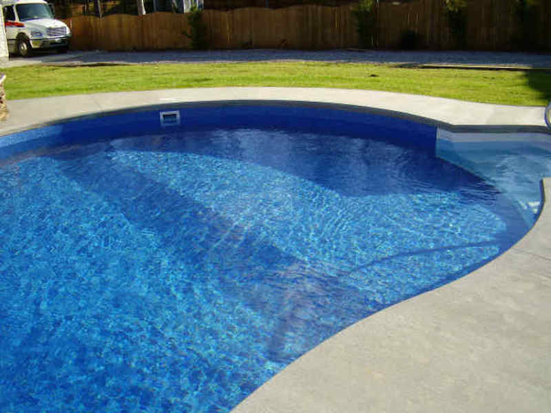 Pool - backyard custom-shaped pool idea