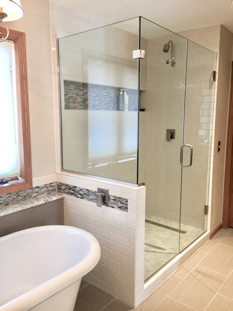 Inspiration for a transitional master multicolored tile and mosaic tile porcelain tile and brown floor freestanding bathtub remodel with shaker cabinets, white cabinets, a vessel sink, quartz countertops, a hinged shower door and multicolored countertops