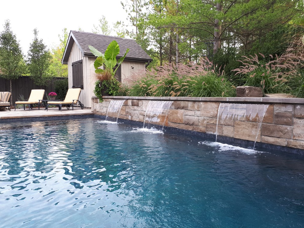 Small transitional backyard concrete paver and rectangular pool fountain photo