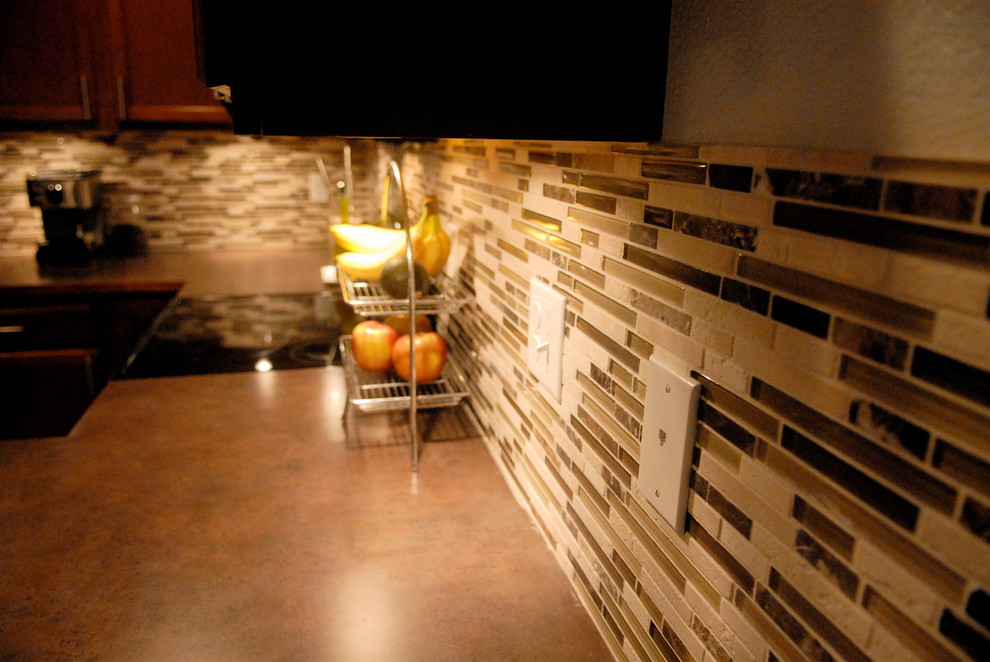 Inspiration for a mid-sized transitional u-shaped medium tone wood floor open concept kitchen remodel in Seattle with a drop-in sink, shaker cabinets, medium tone wood cabinets, wood countertops, multicolored backsplash, matchstick tile backsplash, black appliances and a peninsula
