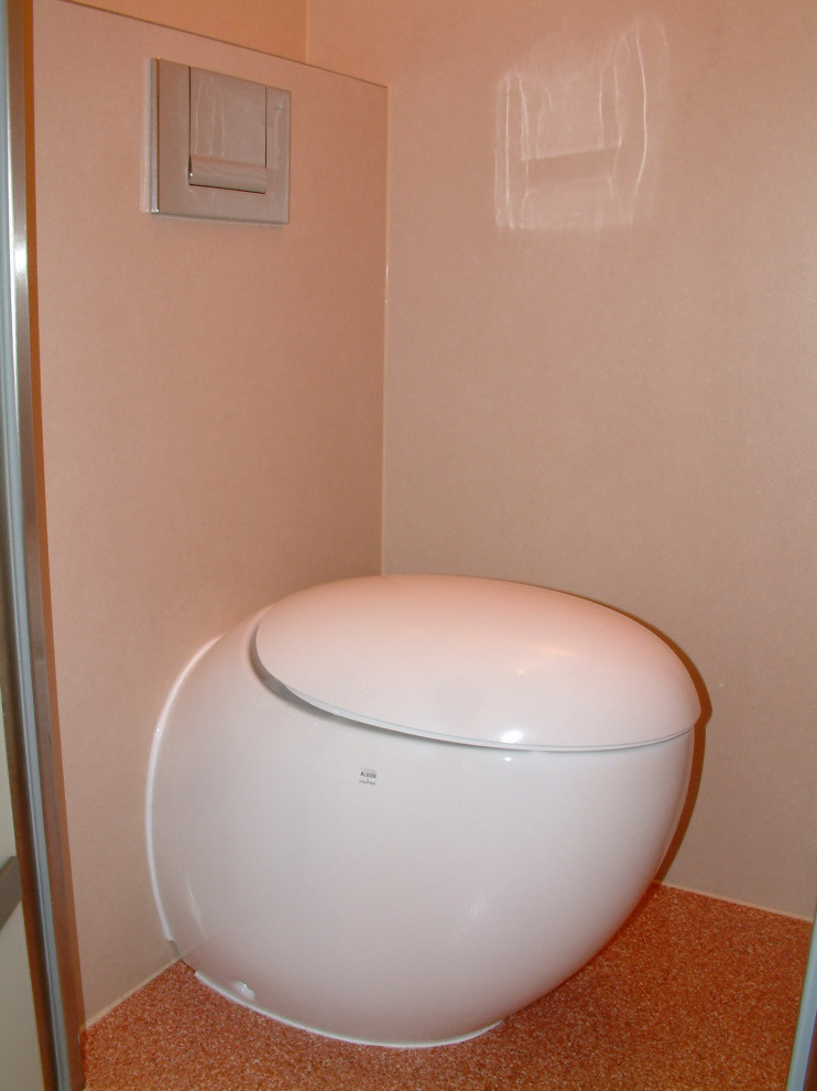 Inspiration for a large classic cloakroom in Munich with a wall mounted toilet, brown tiles, glass tiles, beige walls, lino flooring, a vessel sink, glass worktops, orange floors, beige worktops and a floating vanity unit.