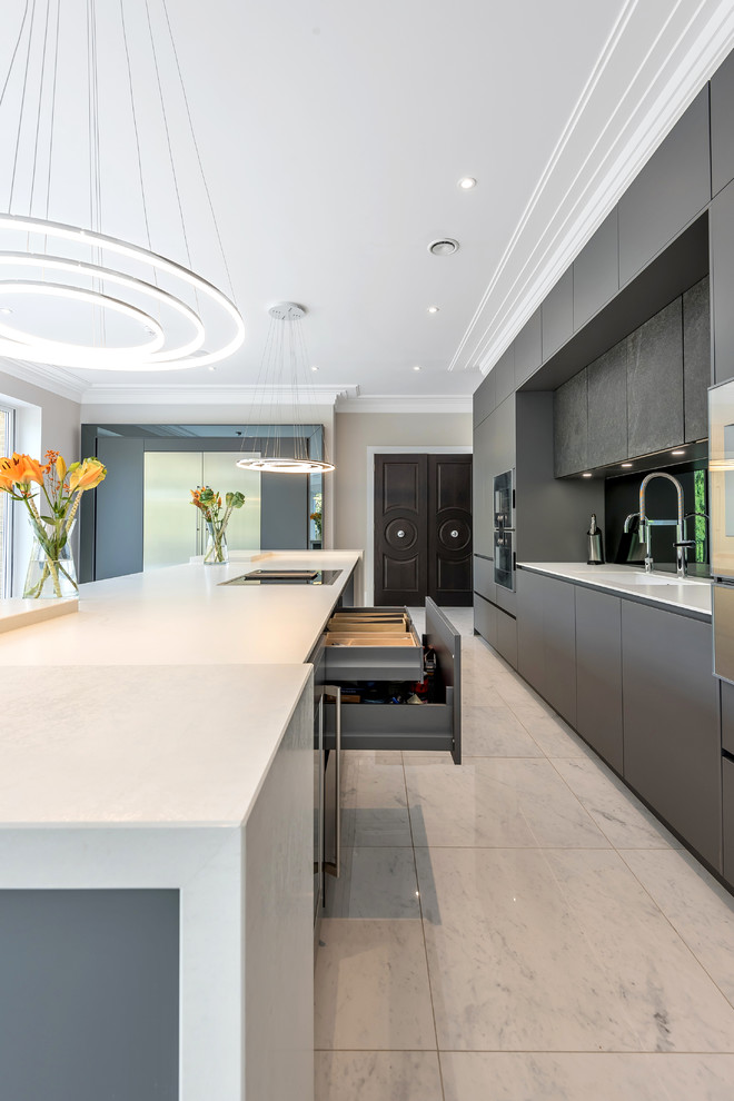 This is an example of a modern single-wall open plan kitchen in Berkshire with flat-panel cabinets, grey cabinets, mirror splashback, marble floors, with island and white floor.