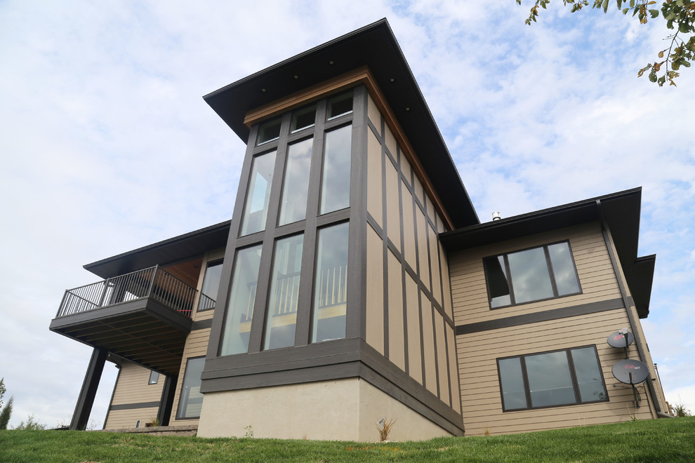 Home design - large transitional two-story brick gray home design idea with a hip roof