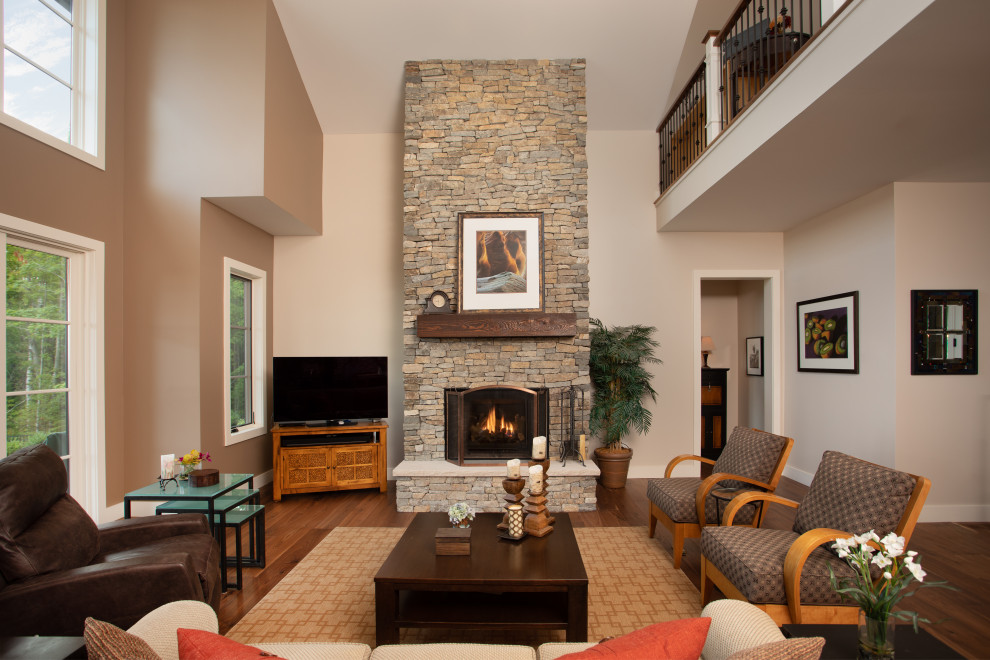 Photo of a large contemporary open concept living room in Other with medium hardwood floors, a standard fireplace, a stone fireplace surround and brown floor.