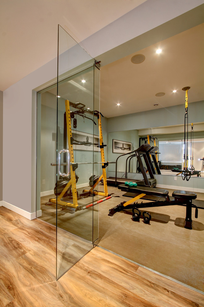 Design ideas for a mid-sized contemporary home weight room in Edmonton with grey walls and cork floors.