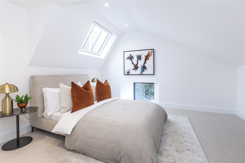 Mid-sized transitional master bedroom in London with white walls, carpet and grey floor.