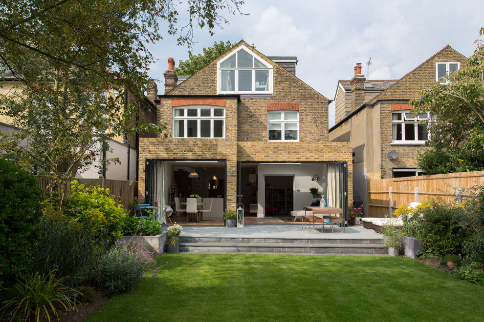 Design ideas for a medium sized and beige contemporary bungalow brick house exterior in London.