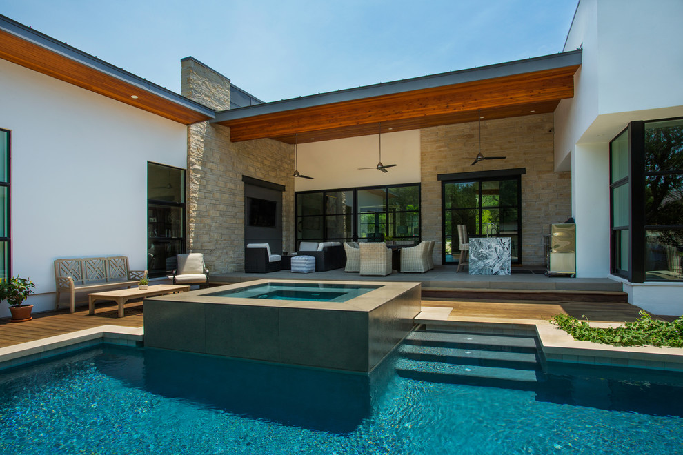 Photo of a mid-sized contemporary backyard custom-shaped aboveground pool in Austin with decking.