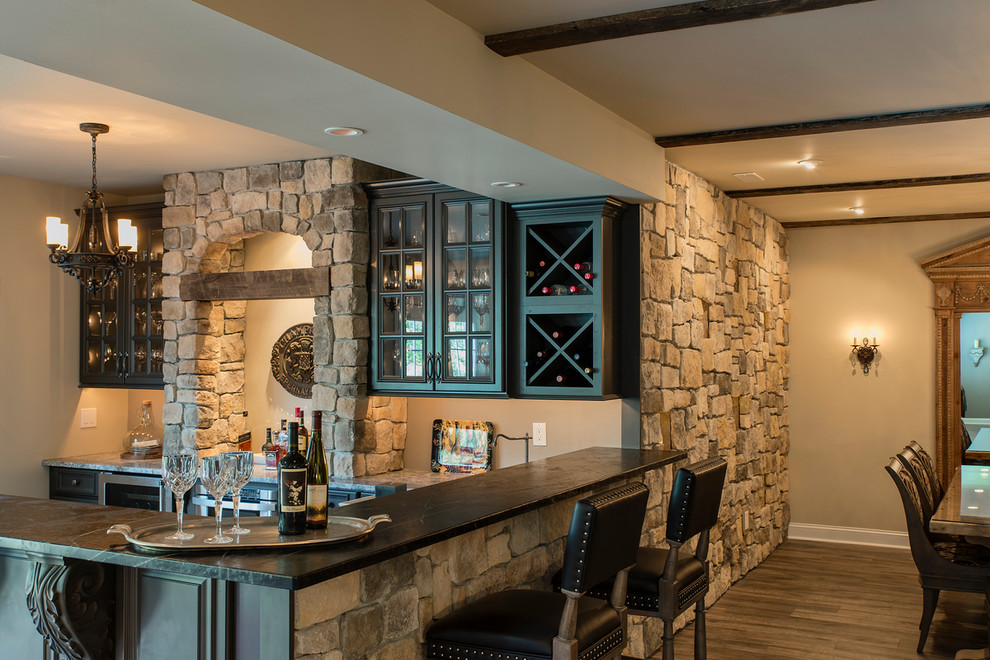Photo of a country l-shaped seated home bar in Wilmington with raised-panel cabinets, black cabinets and dark hardwood floors.