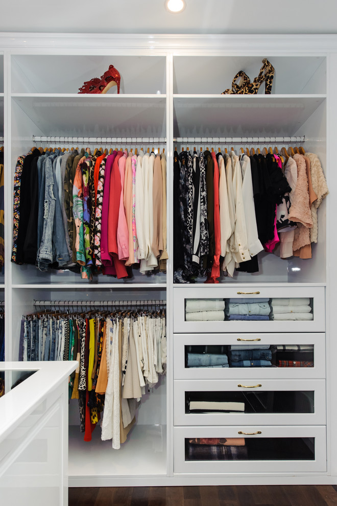 Inspiration for an expansive modern women's walk-in wardrobe in Sydney with dark hardwood floors, open cabinets, white cabinets and brown floor.