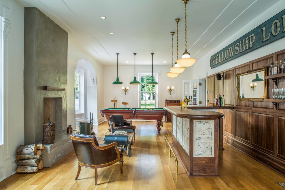 Large traditional galley seated home bar in Toronto with wood benchtops, medium hardwood floors, medium wood cabinets, brown splashback, brown floor and brown benchtop.