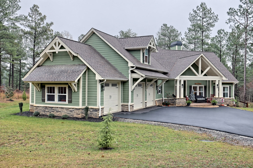 Large arts and crafts two-storey green house exterior in Atlanta with concrete fiberboard siding, a gable roof, a shingle roof, a brown roof and clapboard siding.