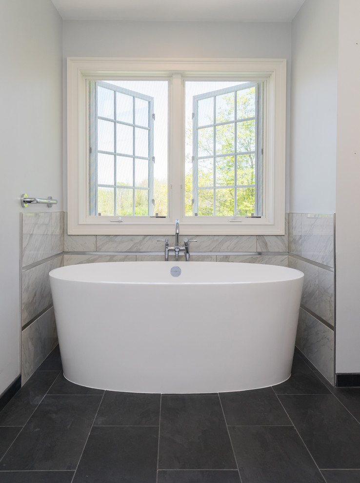 Inspiration for a large transitional master bathroom in Philadelphia with flat-panel cabinets, blue cabinets, a freestanding tub, an open shower, a two-piece toilet, gray tile, porcelain tile, grey walls, porcelain floors, an undermount sink, granite benchtops, grey floor, an open shower and grey benchtops.