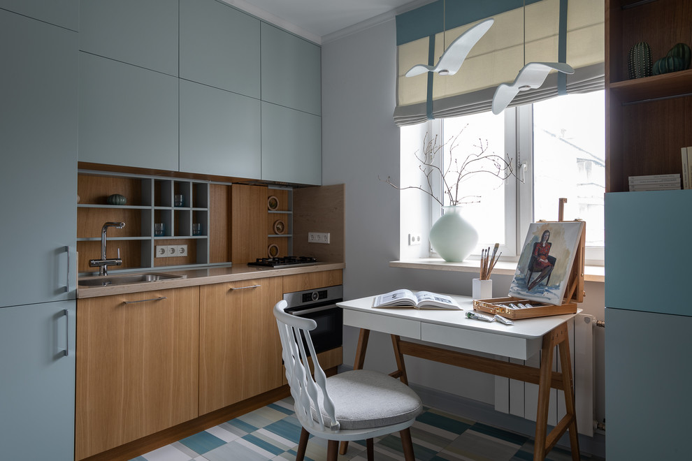 Photo of a small contemporary kitchen in Moscow with flat-panel cabinets, beige benchtop, an undermount sink, medium wood cabinets, quartz benchtops, beige splashback, timber splashback, black appliances, ceramic floors and white floor.