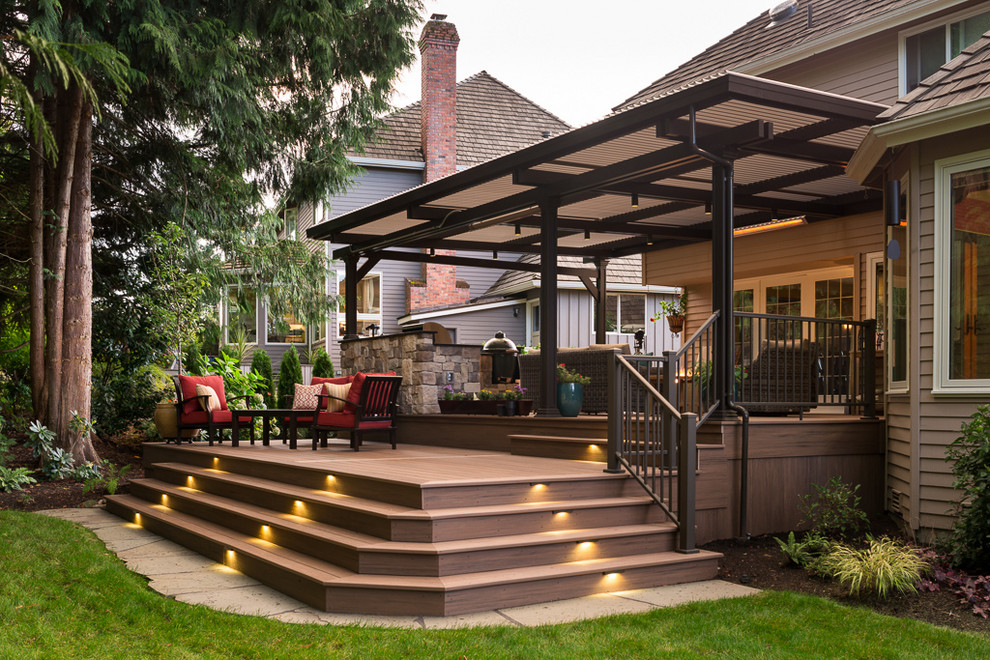 Large transitional backyard deck in Seattle with an outdoor kitchen and a pergola.