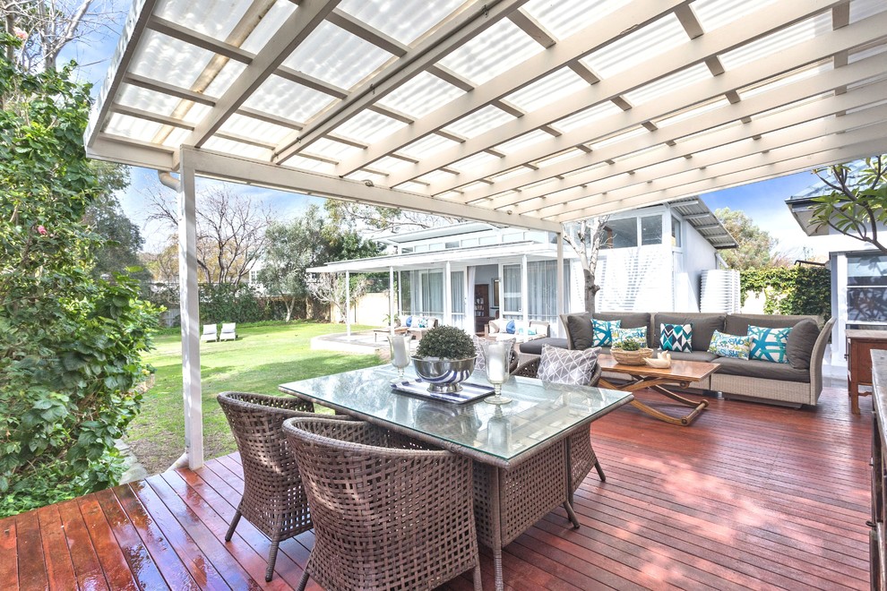 This is an example of a mid-sized contemporary backyard deck in Perth with a pergola.