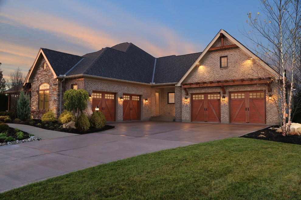 Photo of a large traditional attached four-car garage in Other.