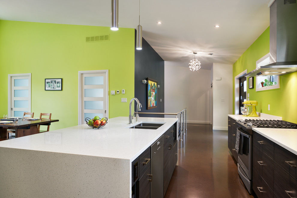 Photo of a mid-sized contemporary single-wall open plan kitchen in Toronto with an undermount sink, flat-panel cabinets, dark wood cabinets, quartz benchtops, green splashback, stainless steel appliances, concrete floors and with island.
