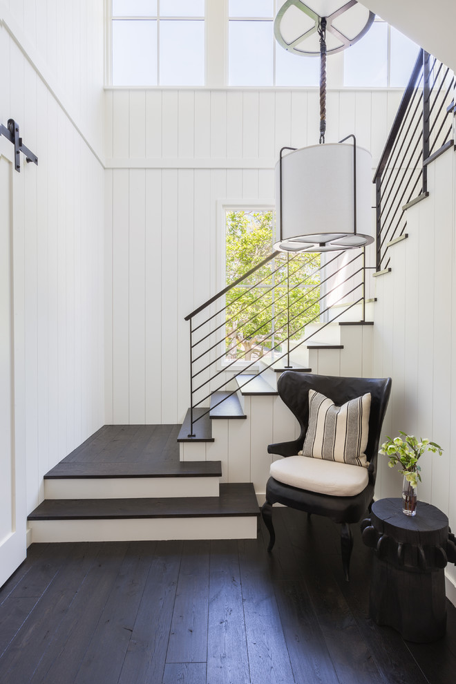 This is an example of a country wood l-shaped staircase in San Francisco with painted wood risers.