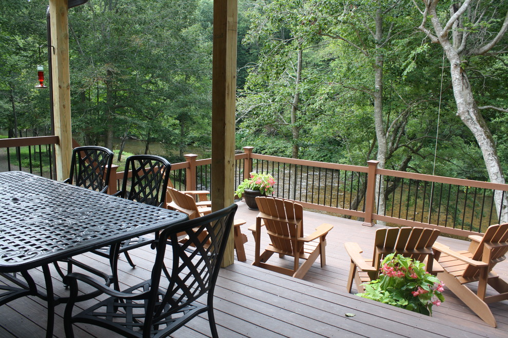 Inspiration for a mid-sized rustic backyard deck remodel in Raleigh with a roof extension