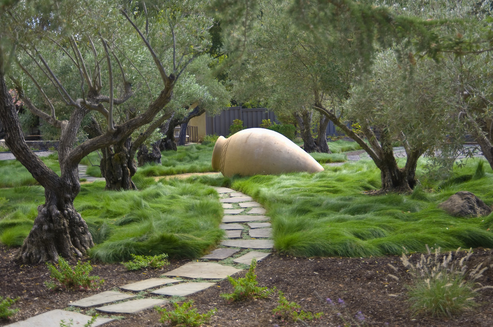 This is an example of a contemporary backyard garden in San Francisco with natural stone pavers.