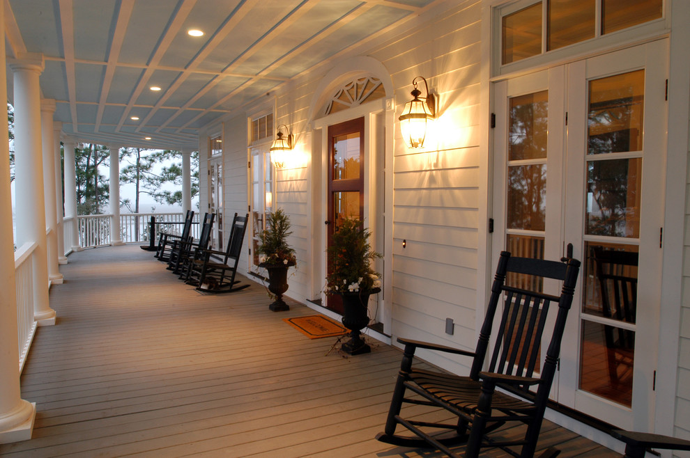 Inspiration for a large traditional front yard verandah in Charleston with decking, a roof extension and with columns.