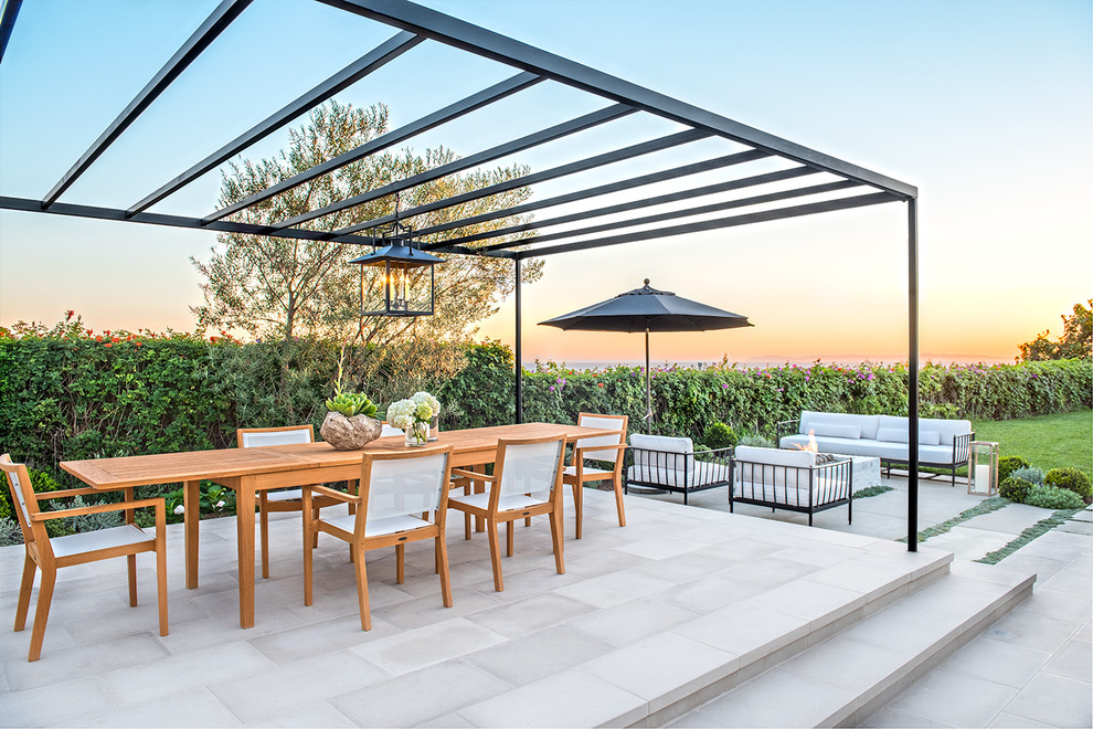 Inspiration for a transitional patio in Orange County with concrete pavers and a pergola.