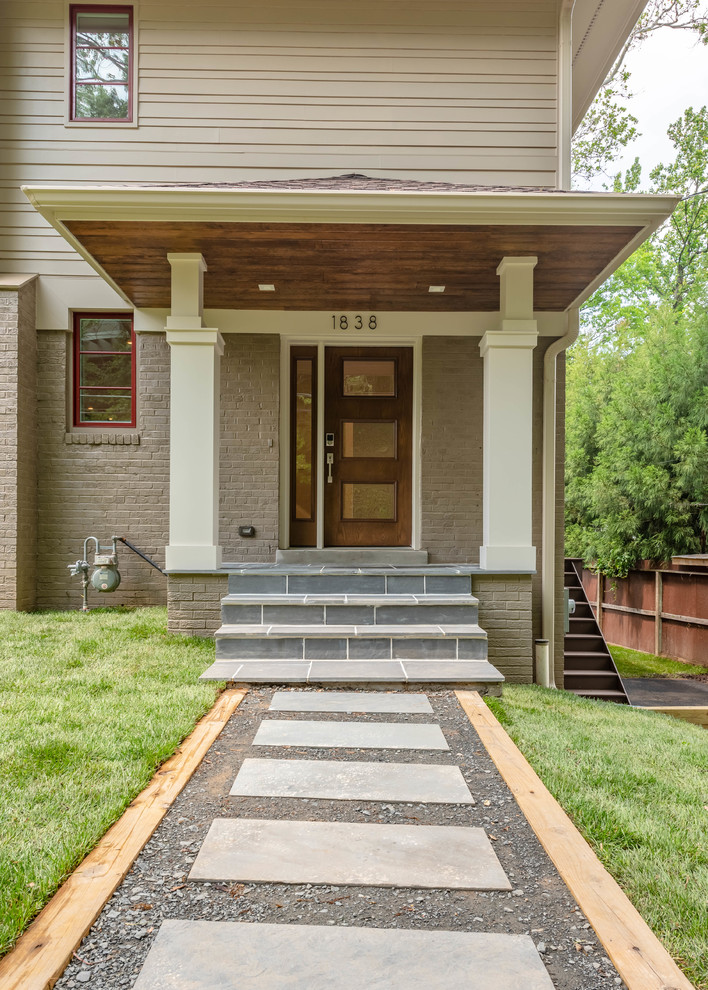 Example of a mid-sized transitional beige two-story mixed siding gable roof design in DC Metro with a shingle roof