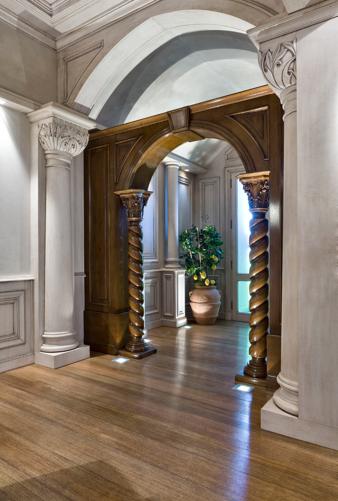 Inspiration for a mid-sized traditional hallway in Milan with white walls and medium hardwood floors.