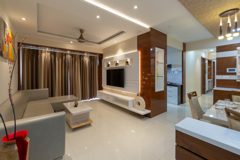 Mid-sized contemporary open concept living room in Pune with beige walls, a wall-mounted tv, beige floor and wood walls.