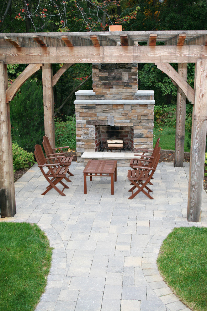 Design ideas for a traditional patio in Grand Rapids with a fire feature and a pergola.