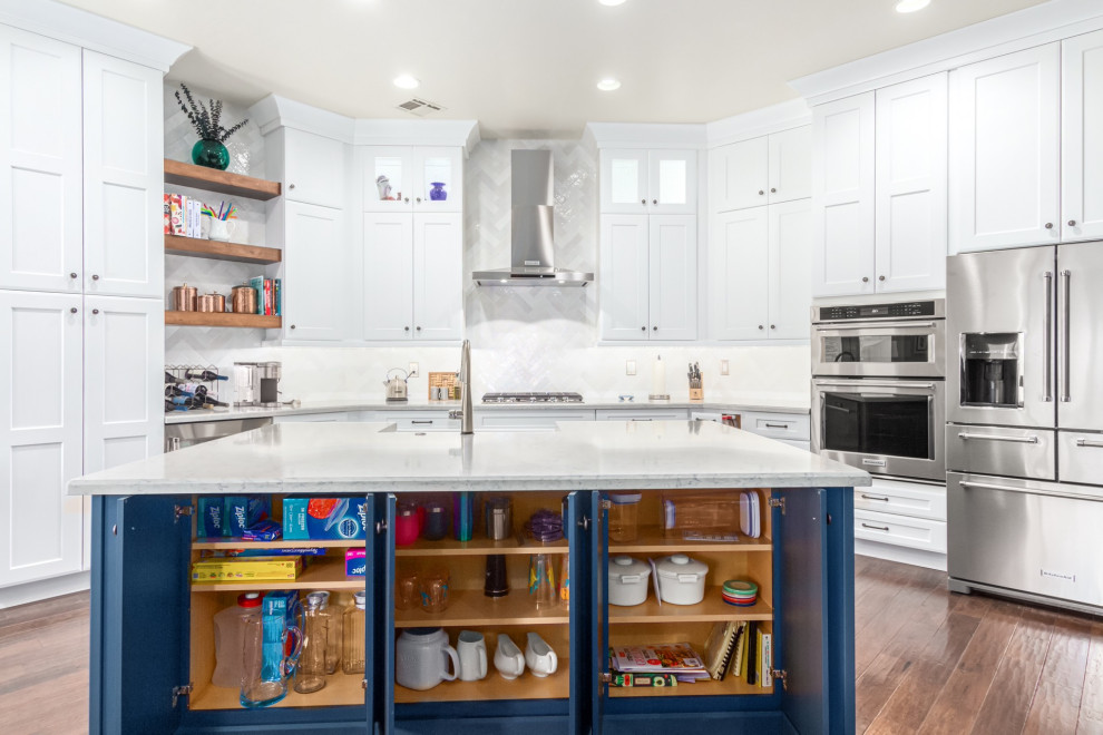 Kitchen - transitional kitchen idea in Phoenix with a farmhouse sink, shaker cabinets, white cabinets, white backsplash, subway tile backsplash and white countertops