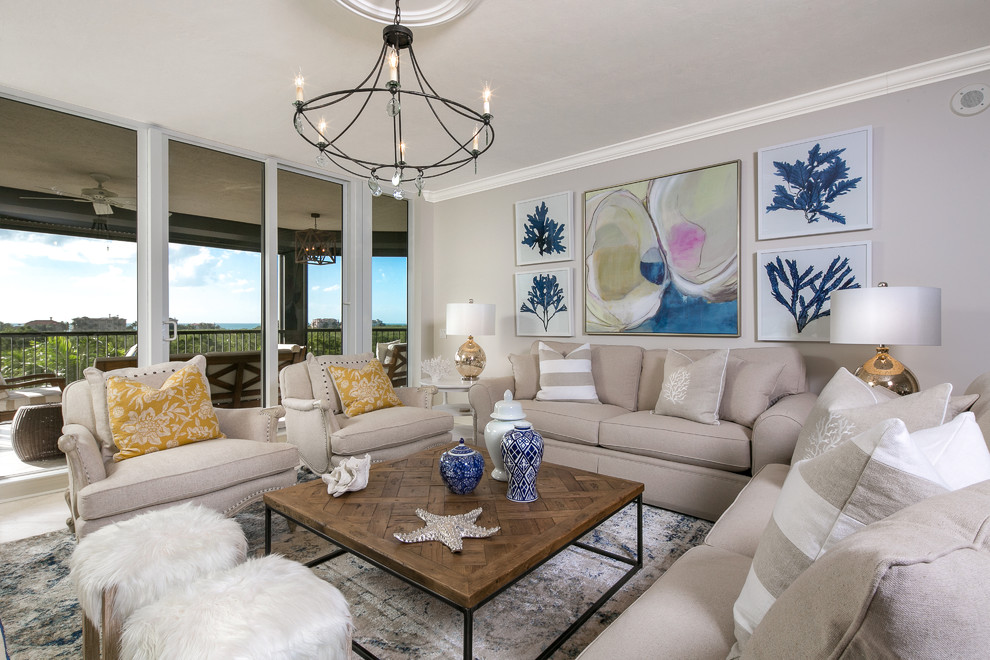 Design ideas for a large beach style open concept family room in Tampa with beige walls, a wall-mounted tv and travertine floors.