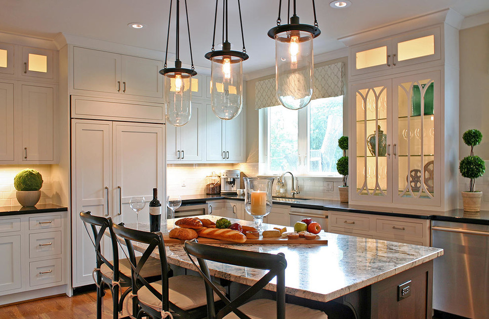 Example of a large transitional medium tone wood floor kitchen design in Houston with an undermount sink, recessed-panel cabinets and an island