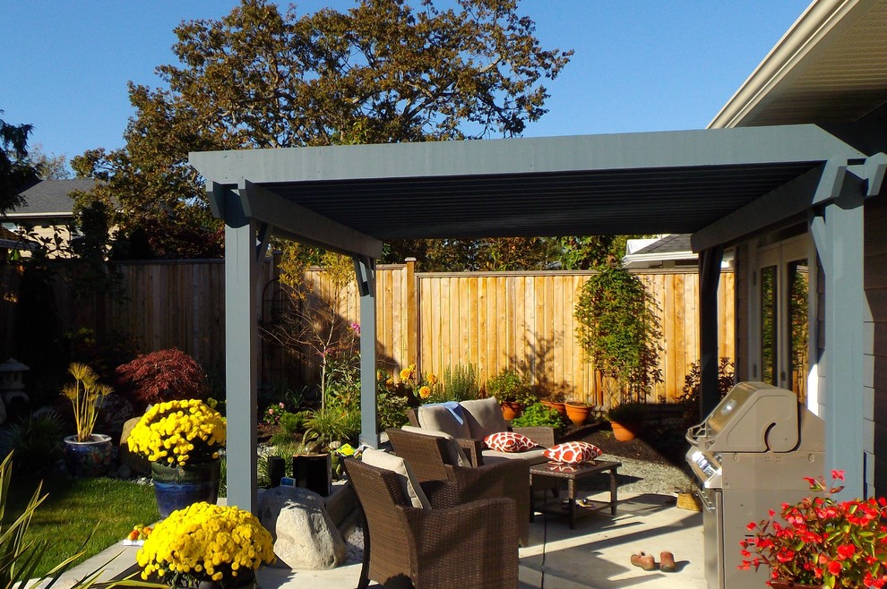 Mid-sized transitional backyard concrete patio photo with a roof extension