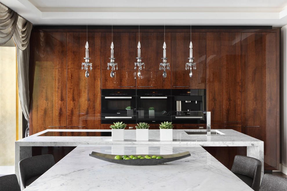 Photo of a contemporary single-wall eat-in kitchen in London with dark wood cabinets and marble benchtops.
