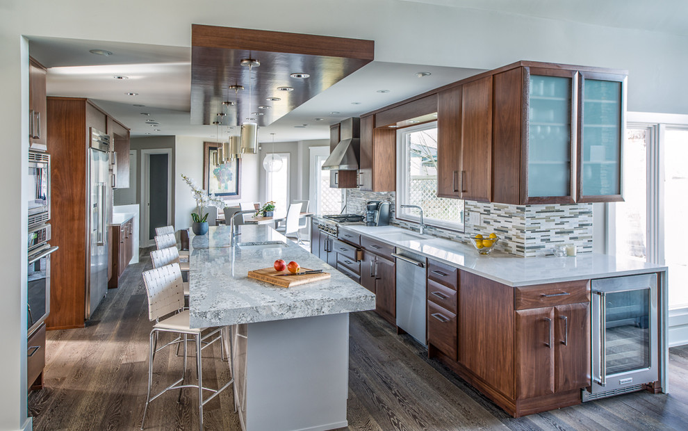 Large modern eat-in kitchen in Indianapolis with an undermount sink, flat-panel cabinets, dark wood cabinets, quartzite benchtops, multi-coloured splashback, mosaic tile splashback, stainless steel appliances, medium hardwood floors and with island.