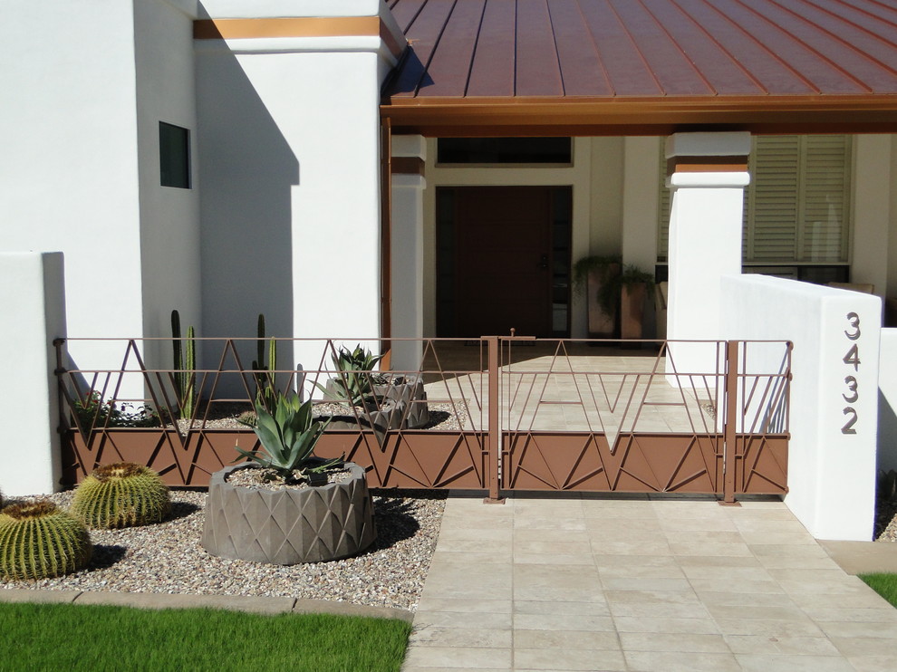 This is an example of a contemporary courtyard patio in Phoenix with tile.