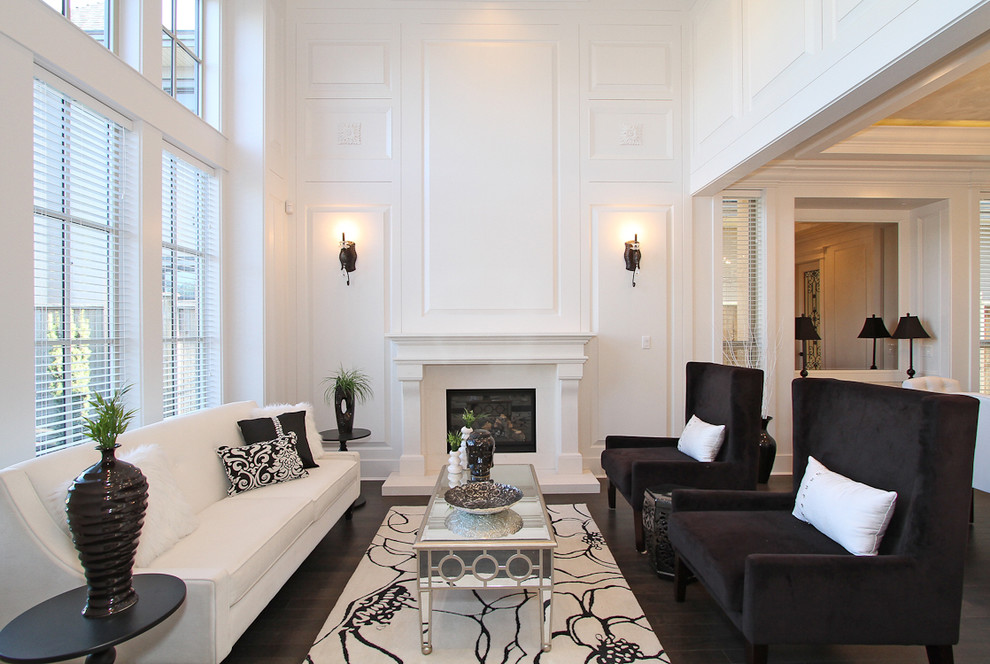 Inspiration for a transitional formal enclosed living room in Vancouver with white walls, dark hardwood floors, a standard fireplace and a wood fireplace surround.