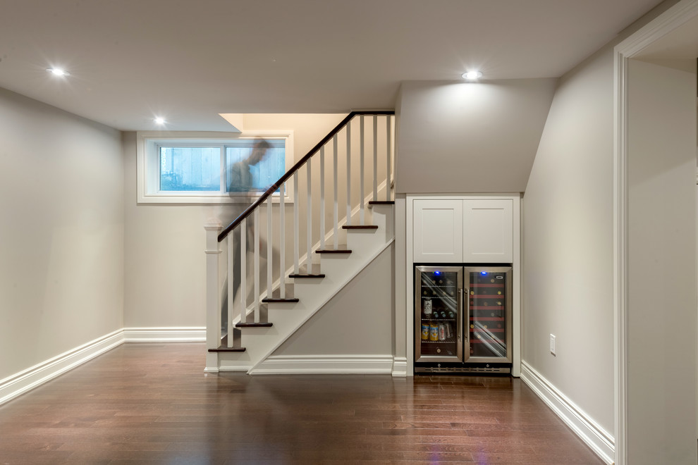 Photo of a small transitional look-out basement in Toronto with grey walls, medium hardwood floors and no fireplace.
